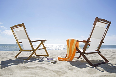 Sun chairs on sandy beach