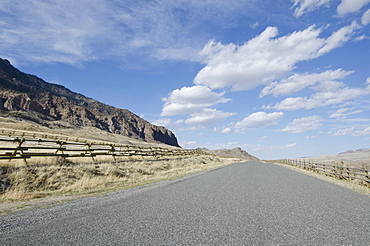 Road going through arid landscape, Wyoming