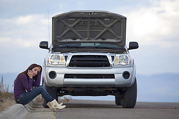 Woman calling for assistance after vehicle breakdown, Whitefish, Montana, USA