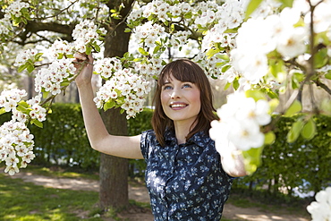 Portrait of young woman in spring orchard