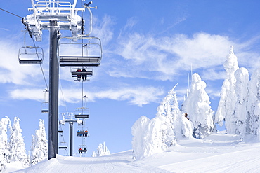 People using chair lift in ski resort