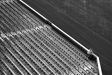 Distant view of couple and stadium bleachers