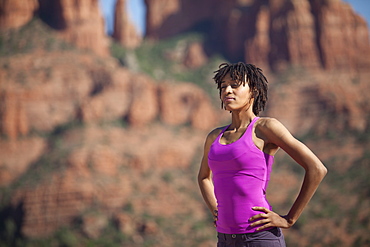 USA, Arizona, Sedona, Young woman standing at desert