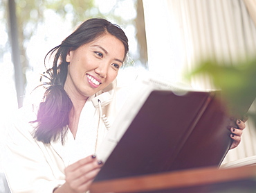 Woman ordering room service in hotel