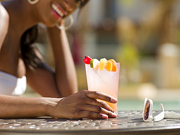 Young woman at pool side bar