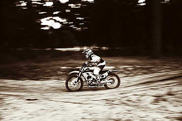 USA, Texas, Austin, Cross motorcyclist on sandy track