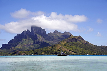 Sailboat with islands at background, French Polynesia, Bora Bora