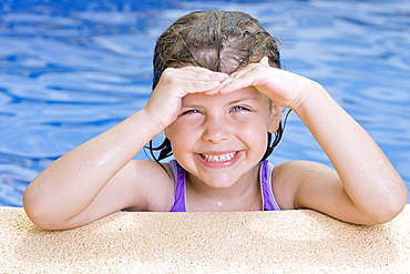 Spain, Costa Blanca, Portrait of smiling girl (6-7) in swimming pool