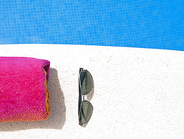 Spain, Costa Blanca, Sunglasses and towel