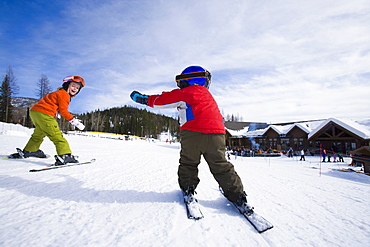 USA, Montana, Whitefish, Boy (4-5) and girl (8-9) skiing