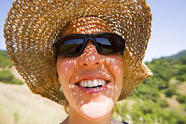 USA, California, Woman wearing straw hat