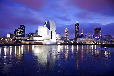 USA, Ohio, Rock and Roll Hall of Fame and Museum across frozen lake at dusk