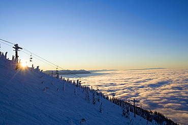 USA, Montana, Whitefish, Ski lift on mountain over clouds