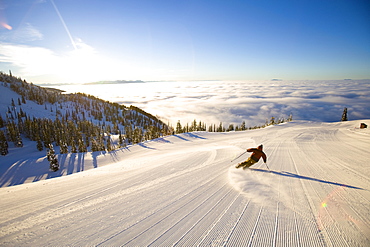 USA, Montana, Whitefish, Male skier on mountain slope at sunrise