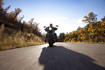 USA, Colorado, Carbondale, Mature man driving motorcycle