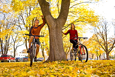 USA, Montana, Kalispell, Portrait of couple at bikes in park