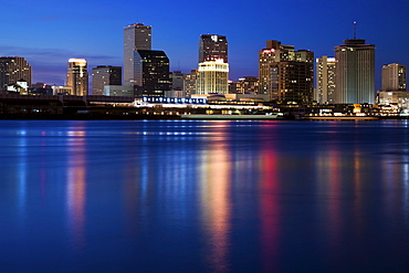 USA, Louisiana, New Orleans, Mississippi River and skyline illuminated at night