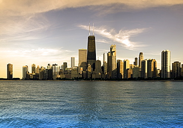 USA, Illinois, Chicago, City skyline over Lake Michigan at sunset