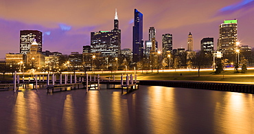 USA, Illinois, Chicago, City skyline and marina illuminated at dusk