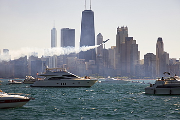 USA, Illinois, Chicago, motor boats and airplane with cityscape at background