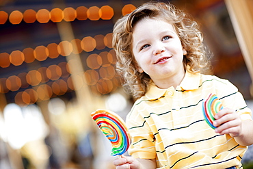 USA, California, Los Angeles, Boy (4-5) holding lollipop and looking away