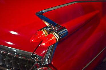 Tail fin on a 1959 red automobile