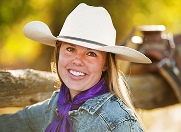 Cowgirl beside fence