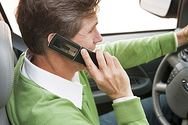 Man using cellular phone while driving