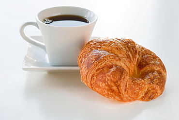 Studio shot of coffee and croissant