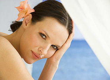 Close up of woman with flower in hair