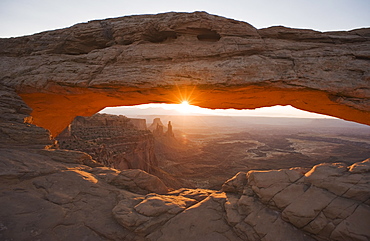 Sun shining behind Mesa Arch, Canyonlands National Park, Utah