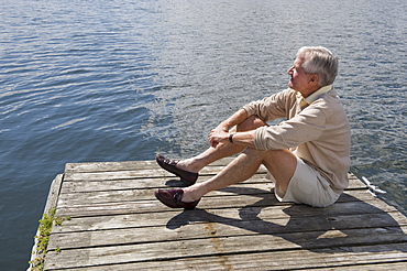 Senior man sitting on dock