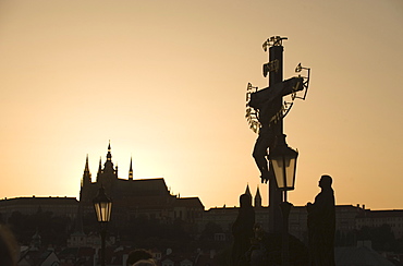 Silhouetted crucifix and cathedral