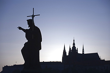 Silhouetted statue and cathedral