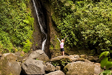 Woman under waterfall, Costa Rica