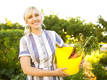 Woman picking vegetables in garden, Salt Lake City, Utah