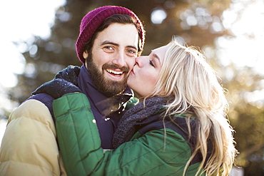 Woman kissing man's cheek