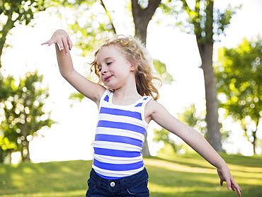 Blonde girl (4-5) dancing in park, USA, Utah, Salt Lake City 