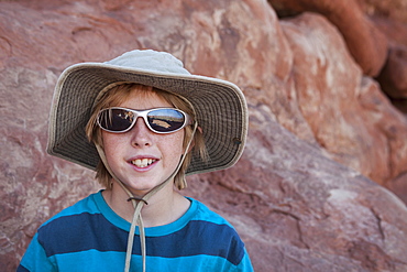Young boy (10-11) hiking, USA, Utah, Arches National Park, Moab