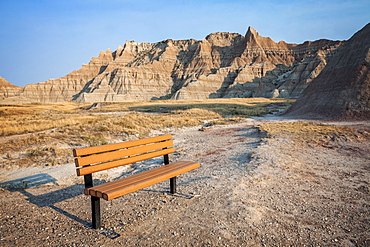 Empty bench with amazing rock formation in the background, USA, South Dakota, Badlands National Park