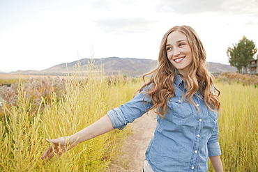 Portrait of young woman on dirt road, Salt Lake City, Utah