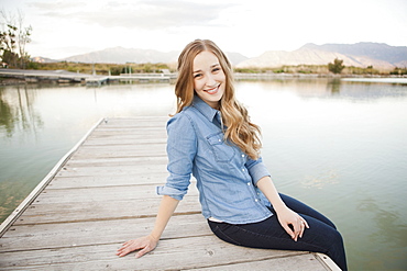 Portrait of young woman sitting on jetty, Salt Lake City, Utah