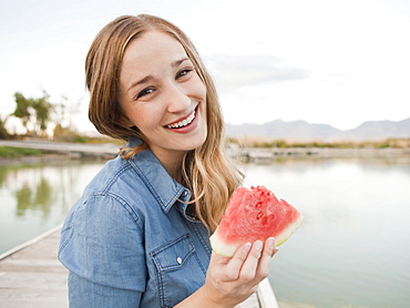 Portrait of young woman eating watermelon, Salt Lake City, Utah