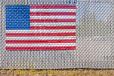 The American flag woven into a chain link fence, Charleston, OR