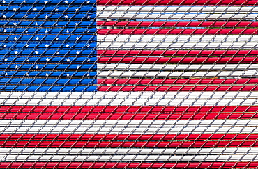 The American flag woven into a chain link fence, Charleston, OR