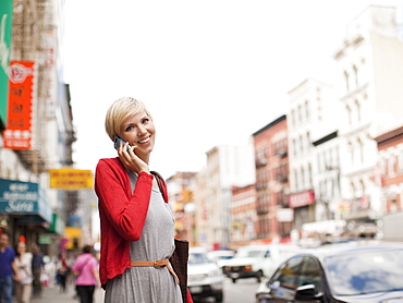 Woman smiling and talking on phone, USA, New York State, New York
