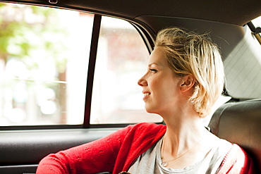 Portrait of woman on back seat of car, USA, New York State, New York