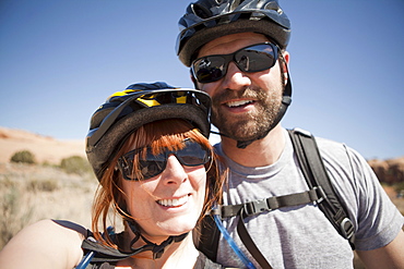 Outdoors portrait of couple in cycling gear