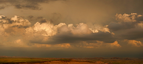 USA, South Dakota, Badlands National Park, Clouds above mountains at sunset