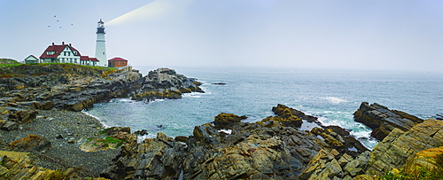 Remote coastline with lighthouse, Portland, Maine